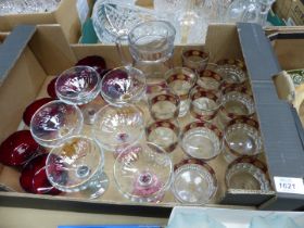 A quantity of glass including champagne bowls with coloured stems, lemonade set, ruby red glasses,