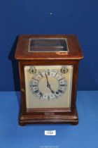 A Mahogany cased Bracket Clock having bevelled glass panels,