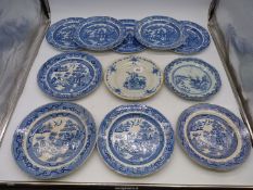 A collection of plates including four blue and white Willow pattern plates,