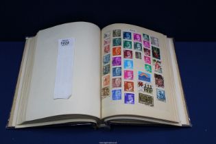 A blue Derwent spring back Stamp Album containing at least 900 different British stamps plus over