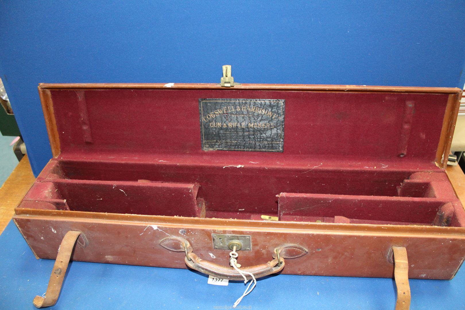 A brown leather Cogswell & Harrison Ltd gun case having red baize fitted interior with key and