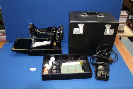 A 1950's portable electric Singer Sewing machine, featherweight, No: 221K1, Serial No: EG344539,