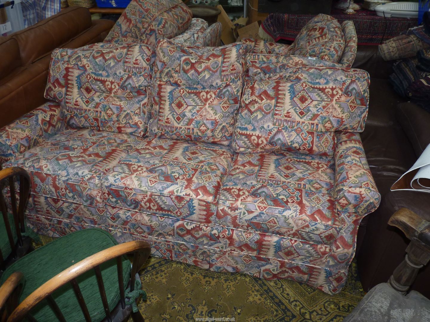 A four piece Lounge Suite comprising a three seater settee, a pair of chairs and a pouffee,