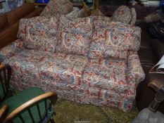 A four piece Lounge Suite comprising a three seater settee, a pair of chairs and a pouffee,