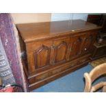 An Oak Sideboard created from an old coffer and having to the front four shaped raised and fielded