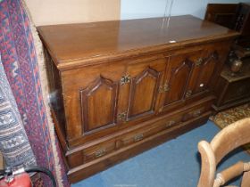 An Oak Sideboard created from an old coffer and having to the front four shaped raised and fielded