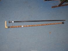 Two walking sticks; one having a silver collar and antler handle,