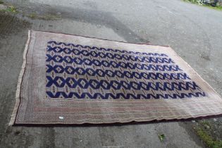 A hand-made wool Turkeman Carpet in deep blue field and repeating gul design, 9'5" x 7'2",