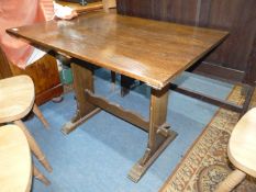 A rectangular Oak Dining Table, the end supports united by a pegged stretcher,