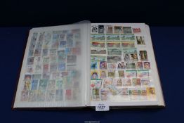 A brown 64 page stock book filled with Commonwealth stamps (approximately 3000).