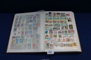 A brown 64 page stock book filled with Commonwealth stamps (approximately 3000).