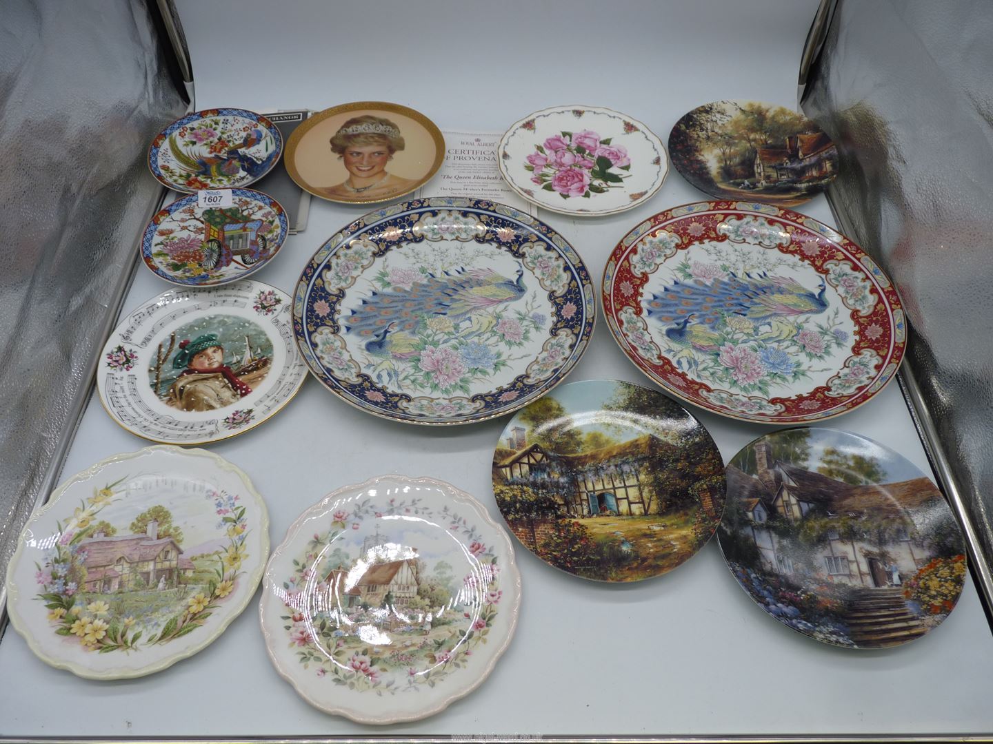 A quantity of display Plates including two peacock design chargers,