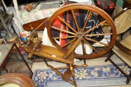 A Spinning Wheel, 26'' diameter, having detachable legs and a treadle.