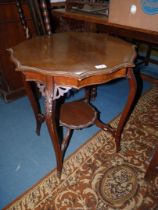 A shaped top Mahogany occasional Table standing on four shaped legs mounted by a lower shelf,