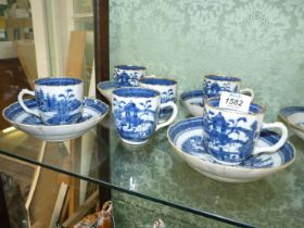 Blue and white matched set of white tea cups and saucers with gilt rims,