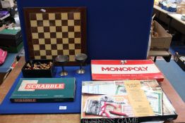 A box of games to include; complete Chess set, Monopoly, Scrabble, etc.