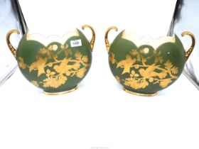 A pair of Staffordshire vases in Recherchee decoration of gold birds on a muted green ground having