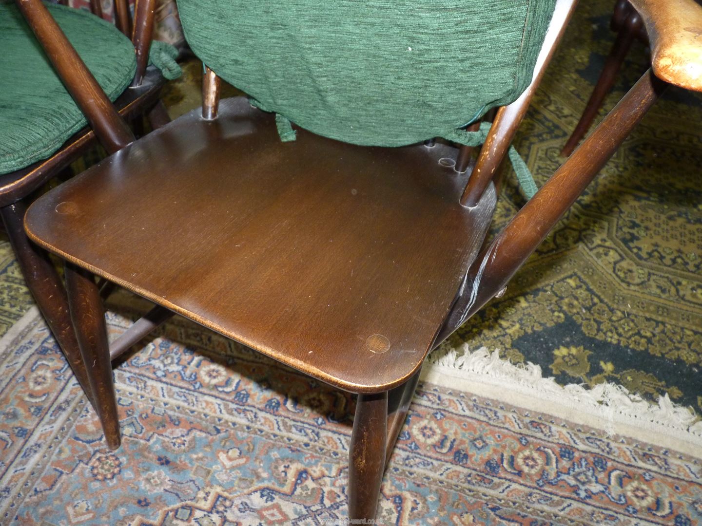 A set of four solid wood seated Ercol Dining Chairs having stick backs and green upholstered pad - Image 2 of 4