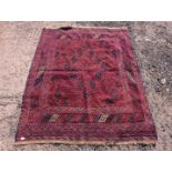 A square border patterned and fringed rug in red and blue having diamond pattern all over 72" x 58".