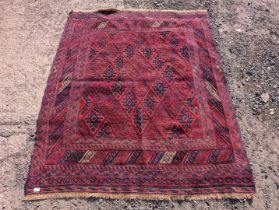 A square border patterned and fringed rug in red and blue having diamond pattern all over 72" x 58".