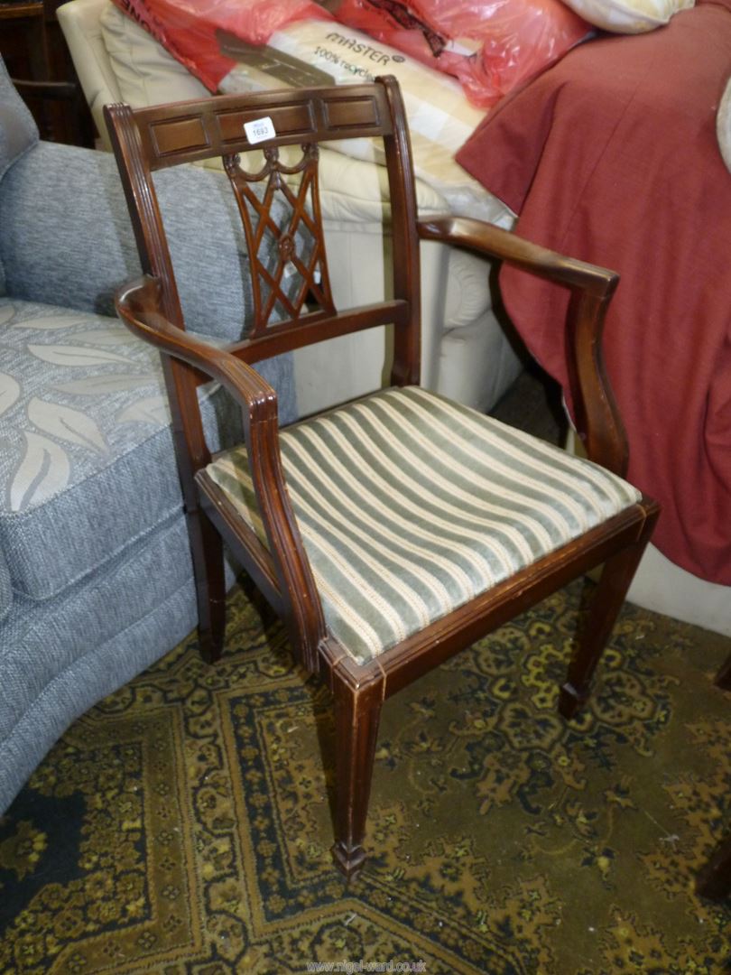 A Mahogany framed open armed Elbow Chair with a striped upholstered drop-in seat and a lattice