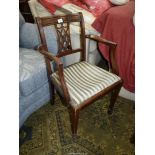 A Mahogany framed open armed Elbow Chair with a striped upholstered drop-in seat and a lattice