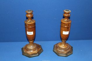 A pair of turned wooden Candlesticks with weighted bases, 12'' tall.