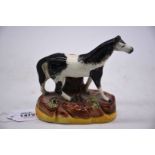 An unusual mid 19th century Staffordshire piebald horse on bocage base, 5 1/2" x 5" tall,