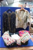A quantity of clothing including; crewel work brightly coloured Kaftan,