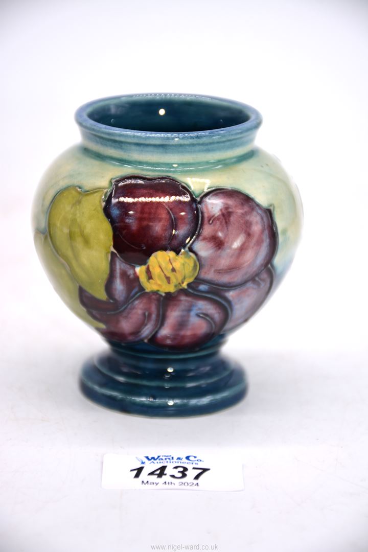 A small Moorcroft vase in Hibiscus pattern, 3 1/2" tall.