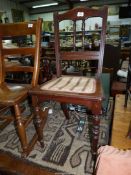 A possibly Edwardian Mahogany framed Bedroom Chair having turned front legs and details to the back,