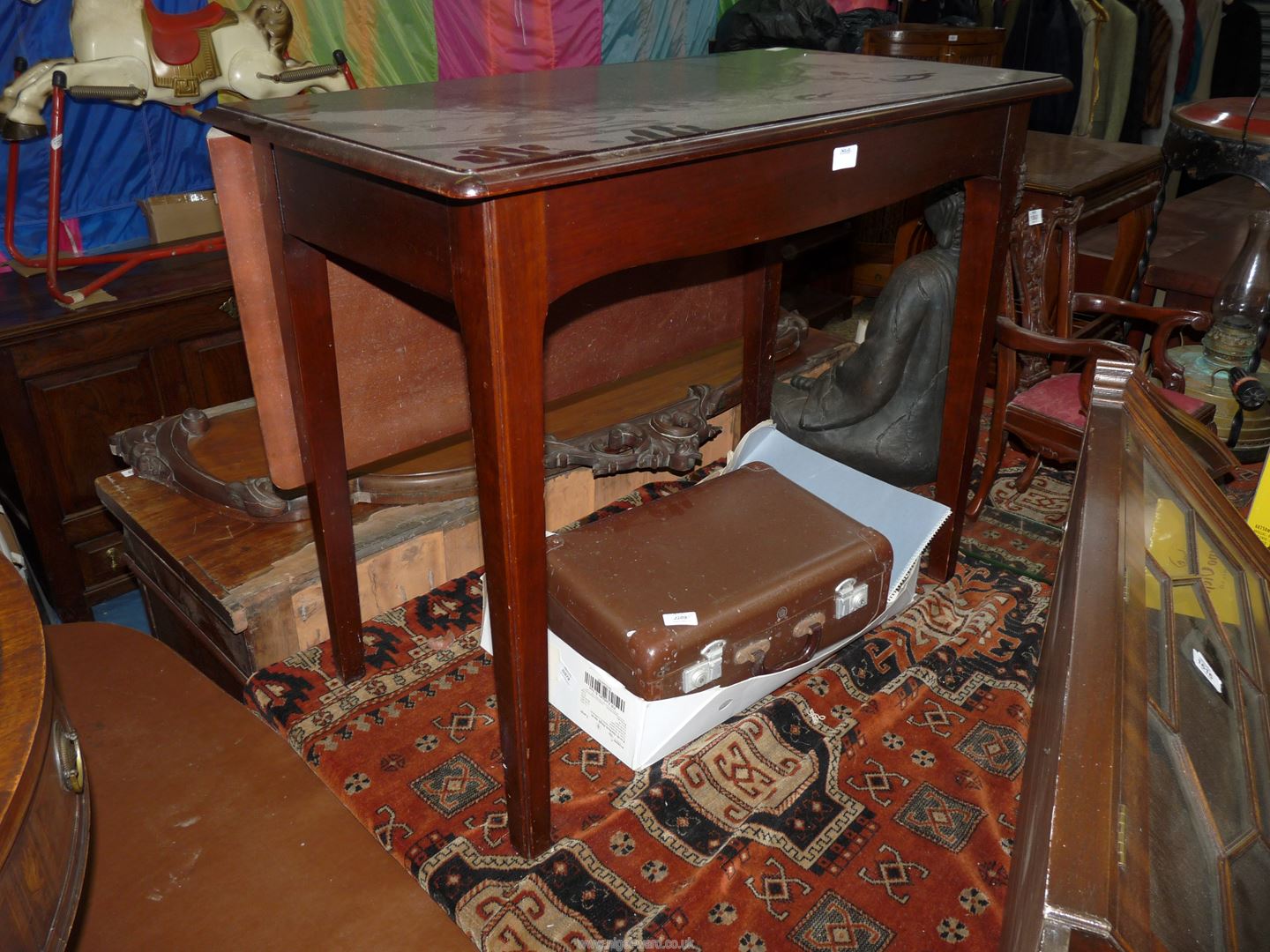 A contemporary Mahogany Side/Dining Table having a frieze drawer to one side and a drop leaf