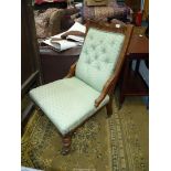A Mahogany framed lady's Fireside Chair standing on turned front legs and upholstered in lattice