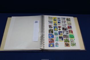 A blue lever Album with interleaves containing approximately 900 different British and World stamps.