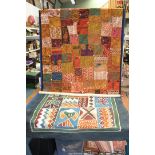 A wall hanging quilt of various heavily embroidered fabric in multi colours having sequin and shell