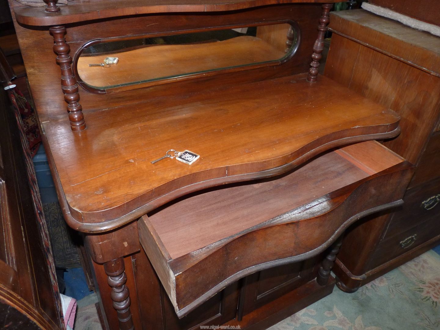 A compact Mahogany Sideboard having a frieze drawer and a pair of opposing drawers below, - Image 2 of 4
