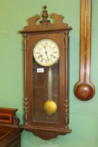 A dark-wood Hermle two-train movement Wall Clock striking the hours on a gong and having Arabic