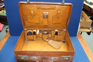 A gentleman's Leather Suitcase with silver topped jars (one jar missing but lid present),