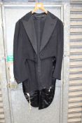 A black Tailcoat suit (for white or black tie), tailcoat having silk lapels,