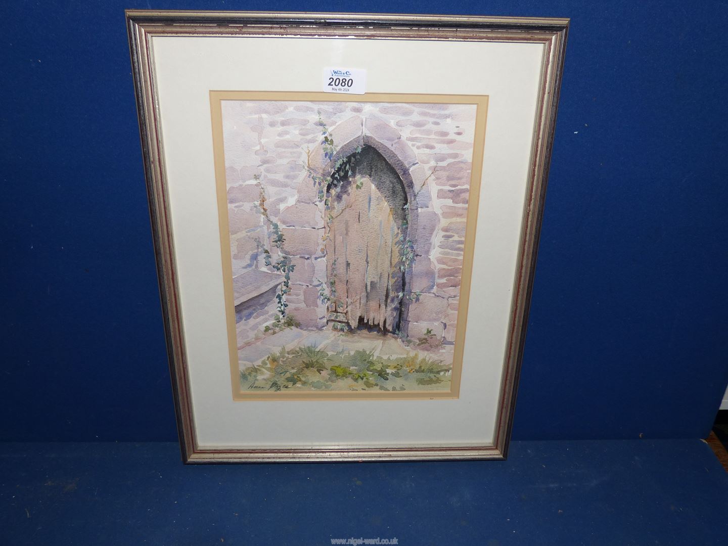 A framed Watercolour 'The Old Door at Skenfrith Church' by Anne Doyle.