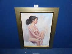 A framed Oil on board depicting a female nude sitting,