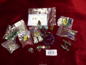 A quantity of large and colourful Earrings including wood effect, Tiger eye, semi-precious, etc.