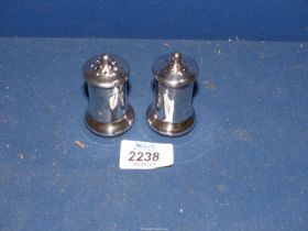 A pair of small Silver salt & pepper Pots, Birmingham 1912, 50 g (some dents).