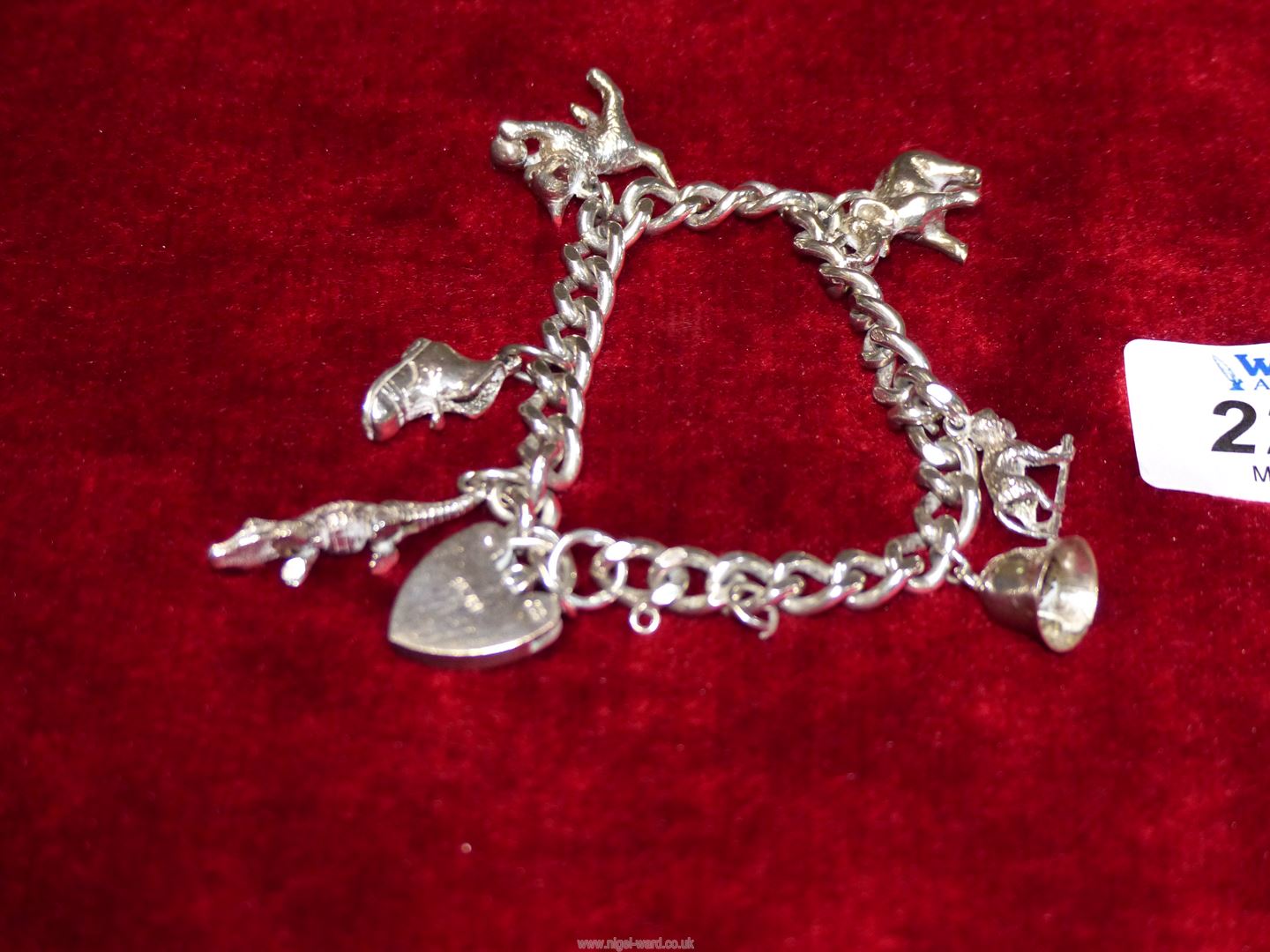 A silver charm Bracelet having heart padlock fastening plus six charms. - Image 2 of 2