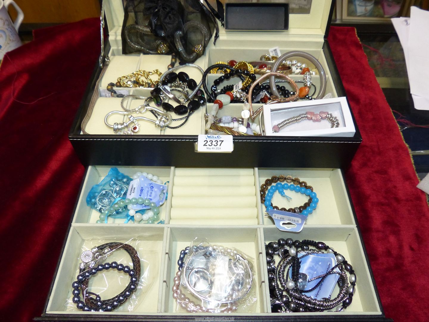 A black jewellery box containing various bracelets including, metal, leather, charm bracelets, - Image 2 of 3