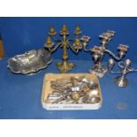 A quantity of plated cutlery, candelabra, etc. plus a brass candelabra.