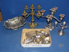 A quantity of plated cutlery, candelabra, etc. plus a brass candelabra.