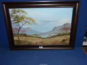 A framed Oil on board depicting an African landscape,