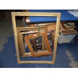A large gilt picture frame, 35" x 27 1/2", plus four additional frames.