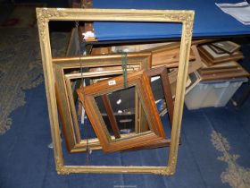 A large gilt picture frame, 35" x 27 1/2", plus four additional frames.